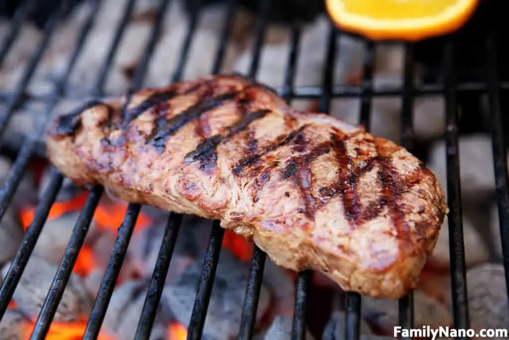 A delicious looking steak cooking on the grill