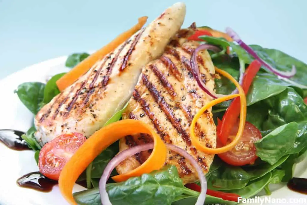 Grilled chicken breast with a spinach salad with a balsamic reduction.