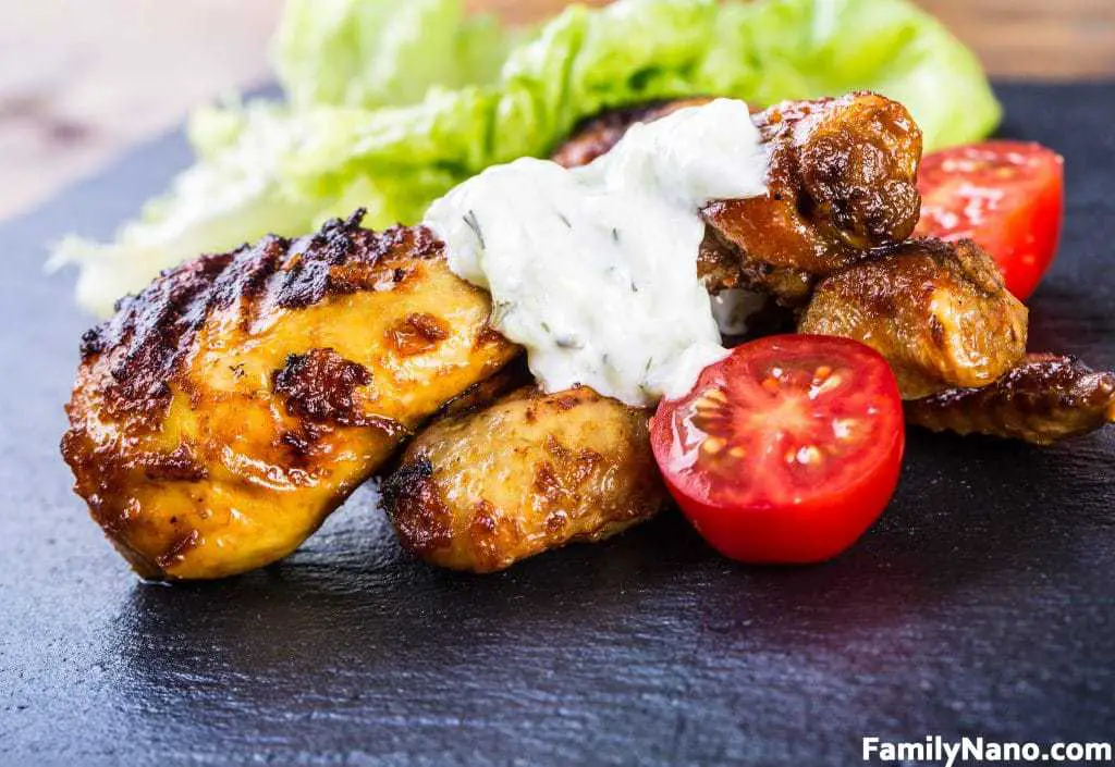Grilling. Grilled chicken. Grilled chicken legs. Grilled chicken legs, lettuce and cherry tomatoes.