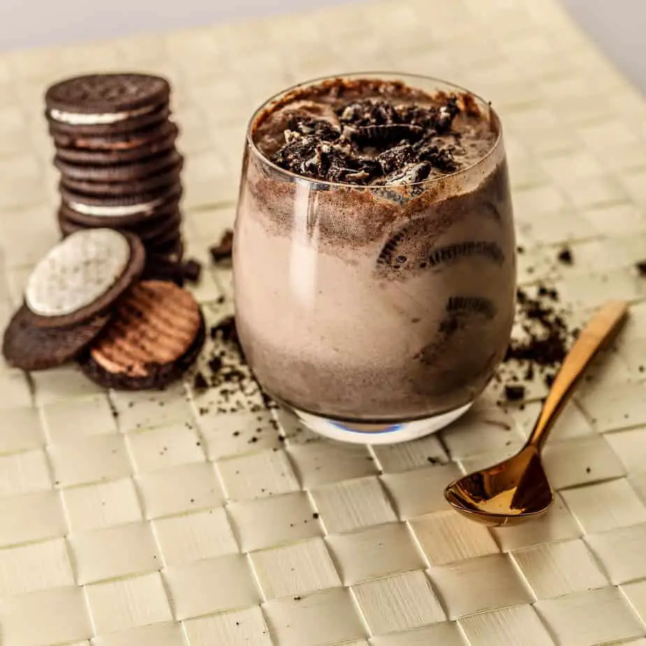 A Chocolate drink with coco cream and cookies
