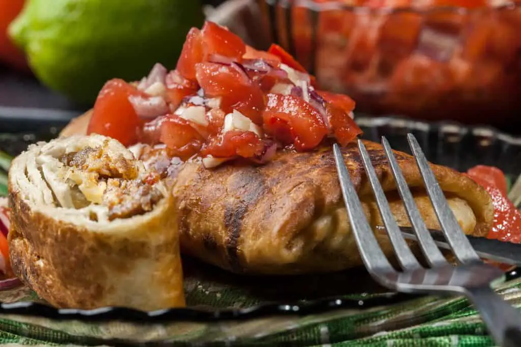 Mexican chimichanga with salsa dip on a plate