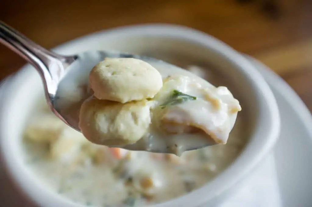 Creamy New England Clam Chowder garnished with oyster crackers