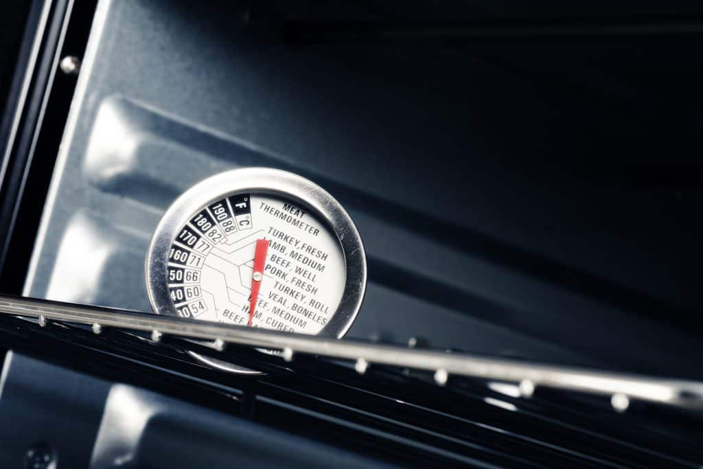 closeup meat thermometer in the oven, utensil in the kitchen